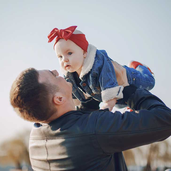 Father holding small child