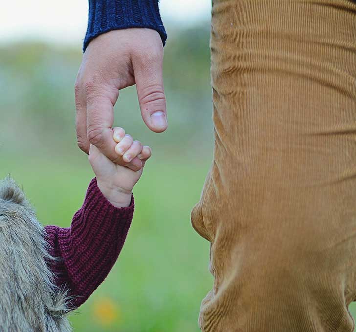 Child holding fathers hand